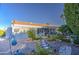 Landscaped backyard featuring mature trees, gravel beds, and a covered patio at 654 S 83Rd Way, Mesa, AZ 85208