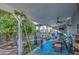 Covered patio area featuring a dining table, seating area, and lush greenery at 654 S 83Rd Way, Mesa, AZ 85208
