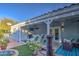 Inviting covered patio with outdoor seating, ceiling fan, and mounted TV at 654 S 83Rd Way, Mesa, AZ 85208