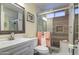 Updated bathroom showcasing a shower with modern tile, and a framed mirror at 654 S 83Rd Way, Mesa, AZ 85208
