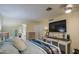 Comfortable bedroom with en-suite bathroom and large-screen television at 654 S 83Rd Way, Mesa, AZ 85208