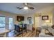 A stylish dining area with a modern table, TV, and French doors leading to outdoor patio at 654 S 83Rd Way, Mesa, AZ 85208