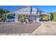 Charming blue home with desert landscape and covered parking at 654 S 83Rd Way, Mesa, AZ 85208