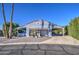 Charming blue home with a well-manicured desert landscape and covered carport at 654 S 83Rd Way, Mesa, AZ 85208