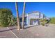 Attractive single-story home with gravel landscaping, mature cactus, palm trees, and ample parking under a bright blue sky at 654 S 83Rd Way, Mesa, AZ 85208