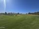 Expansive golf course with lush green fairways and palm trees, offering a serene golfing experience at 654 S 83Rd Way, Mesa, AZ 85208