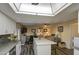 Open-concept kitchen with an island, ceiling fan, connecting dining, and sitting areas at 654 S 83Rd Way, Mesa, AZ 85208