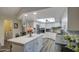 Bright, open kitchen with a large island, white cabinets, stainless steel appliances, and modern finishes at 654 S 83Rd Way, Mesa, AZ 85208