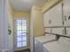 Functional laundry room with white cabinets and matching Samsung washer/dryer set at 654 S 83Rd Way, Mesa, AZ 85208