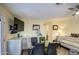 Open floor plan featuring a dining table, sofa, TV, and natural light, great for entertaining at 654 S 83Rd Way, Mesa, AZ 85208