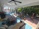 Covered patio with comfortable seating, a ceiling fan, and views of the landscaped backyard at 654 S 83Rd Way, Mesa, AZ 85208