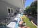 Inviting patio area with white wicker furniture, a ceiling fan, and access to the well-maintained backyard at 654 S 83Rd Way, Mesa, AZ 85208
