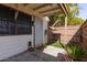 Private back patio enclosed by a wood fence and featuring a secure door, window, and artificial turf at 6604 W Kingston Ln, Glendale, AZ 85306