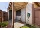 Enclosed back patio features neutral siding, a security door, and a hose, perfect for outdoor activities at 6604 W Kingston Ln, Glendale, AZ 85306