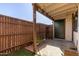 Cozy back patio with wood fencing, string lights, and artificial grass creating a relaxing outdoor space at 6604 W Kingston Ln, Glendale, AZ 85306