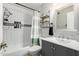 Bathroom features tiled shower, modern vanity, and decorative shelves at 6604 W Kingston Ln, Glendale, AZ 85306
