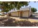 View of home with mature trees providing shade at 6604 W Kingston Ln, Glendale, AZ 85306