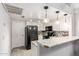 Kitchen features granite countertops, white cabinets, and black appliances at 6604 W Kingston Ln, Glendale, AZ 85306