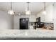 Kitchen with granite countertops, black appliances, and white cabinets at 6604 W Kingston Ln, Glendale, AZ 85306