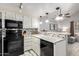Kitchen features white cabinets, black appliances, and granite countertops at 6604 W Kingston Ln, Glendale, AZ 85306