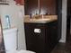 Compact bathroom with a sink vanity and a toilet with tile flooring at 7807 E Main St # D-32, Mesa, AZ 85207