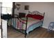 Bedroom featuring a metal frame bed with wooden floors and natural light at 7807 E Main St # D-32, Mesa, AZ 85207