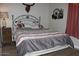 Bedroom featuring a bed, side table, and western decorations on the wall at 7807 E Main St # D-32, Mesa, AZ 85207