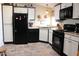 Modern kitchen with black appliances, white cabinets, and tile flooring at 7807 E Main St # D-32, Mesa, AZ 85207