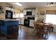 Kitchen with white cabinetry, black appliances, and a cozy breakfast nook at 7807 E Main St # D-32, Mesa, AZ 85207