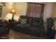Comfortable living room features a gray reclining sofa and lamp for a relaxing ambiance at 7807 E Main St # D-32, Mesa, AZ 85207