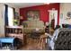 Cozy living room with a decorative red accent wall and comfortable furniture at 7807 E Main St # D-32, Mesa, AZ 85207