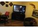 Comfortable den area with TV, desk, and chair, perfect for relaxing and entertainment at 7807 E Main St # D-32, Mesa, AZ 85207