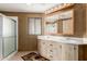 Bathroom with double vanity, shower, and earth tone finishes at 8103 E Southern Ave # 119, Mesa, AZ 85209