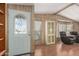 Inviting entryway with decorative glass door, wood paneling, and adjacent living area at 8103 E Southern Ave # 119, Mesa, AZ 85209