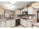 Efficient kitchen featuring black appliances, light countertops, and ample cabinet storage space at 8103 E Southern Ave # 119, Mesa, AZ 85209