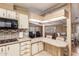Bright kitchen open to living room with breakfast bar, wood accents, and modern appliances at 8103 E Southern Ave # 119, Mesa, AZ 85209