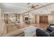 Open concept living room, dining room, and kitchen with cohesive wood detailing and ample seating at 8103 E Southern Ave # 119, Mesa, AZ 85209