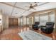 Cozy living room featuring hardwood floors, a ceiling fan, and comfortable furniture at 8103 E Southern Ave # 119, Mesa, AZ 85209
