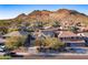 View of a suburban neighborhood with mountain views and a home with solar panels on the roof at 8362 W Rosewood Ln, Peoria, AZ 85383