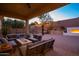 Inviting covered patio with outdoor seating, fireplace, and basketball court, perfect for entertaining at 8362 W Rosewood Ln, Peoria, AZ 85383