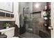 Modern bathroom with a glass-enclosed shower, gray tile, and stylish decor at 8362 W Rosewood Ln, Peoria, AZ 85383
