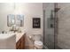 Bathroom featuring dual sinks, a modern glass shower, and a decorative art piece at 8362 W Rosewood Ln, Peoria, AZ 85383
