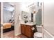 A half bath with a vessel sink and view into the primary bedroom at 8362 W Rosewood Ln, Peoria, AZ 85383