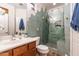 Bathroom featuring stylish green tile, glass shower with a seat, and a modern sink at 8362 W Rosewood Ln, Peoria, AZ 85383