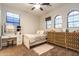 Bright bedroom with arched windows, stylish vanity, and decorative wooden dresser at 8362 W Rosewood Ln, Peoria, AZ 85383