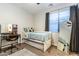 Cozy bedroom featuring a single bed, study desk, large window, and a full-length mirror at 8362 W Rosewood Ln, Peoria, AZ 85383