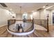 Open foyer with a curved staircase, iron railings, and hardwood floors, creating an inviting entrance at 8362 W Rosewood Ln, Peoria, AZ 85383