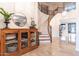 An elegant foyer with a curved staircase, light wood treads, iron railing, and decorative accents at 8362 W Rosewood Ln, Peoria, AZ 85383
