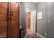 Hallway with a large wooden wardrobe, drink refrigerator, and view into the pantry at 8362 W Rosewood Ln, Peoria, AZ 85383
