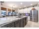 Spacious kitchen featuring white cabinetry, stainless steel appliances, and a large island at 8362 W Rosewood Ln, Peoria, AZ 85383